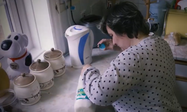 Helen in her kitchen pouring milk